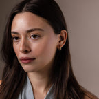 Faraway shot of a model wearing our Oval Duo Hoops in Gold