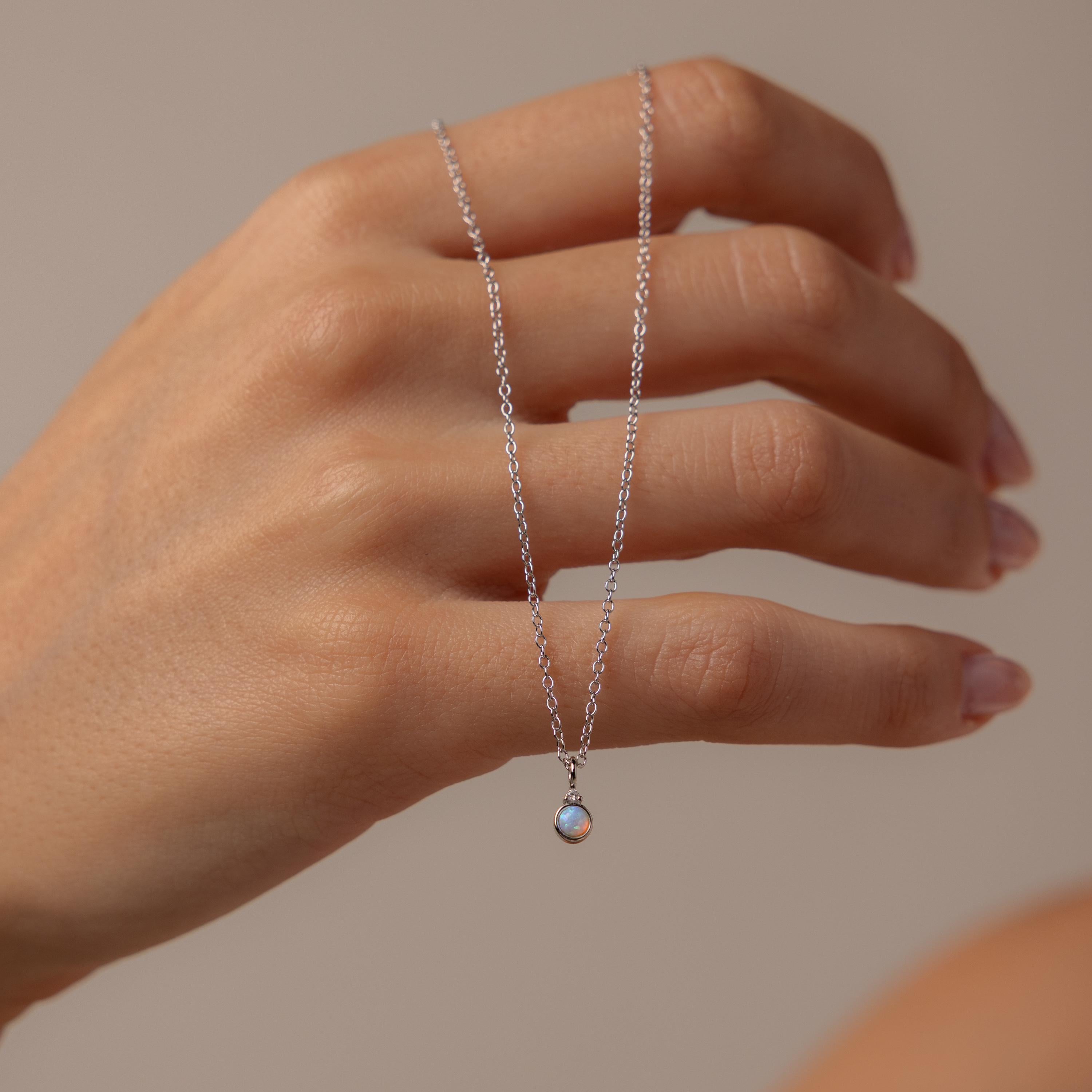 Model holding our Opal Diamond Necklace in Sterling Silver