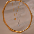 Flatlay of our Opal Diamond Necklace in Gold and Silver