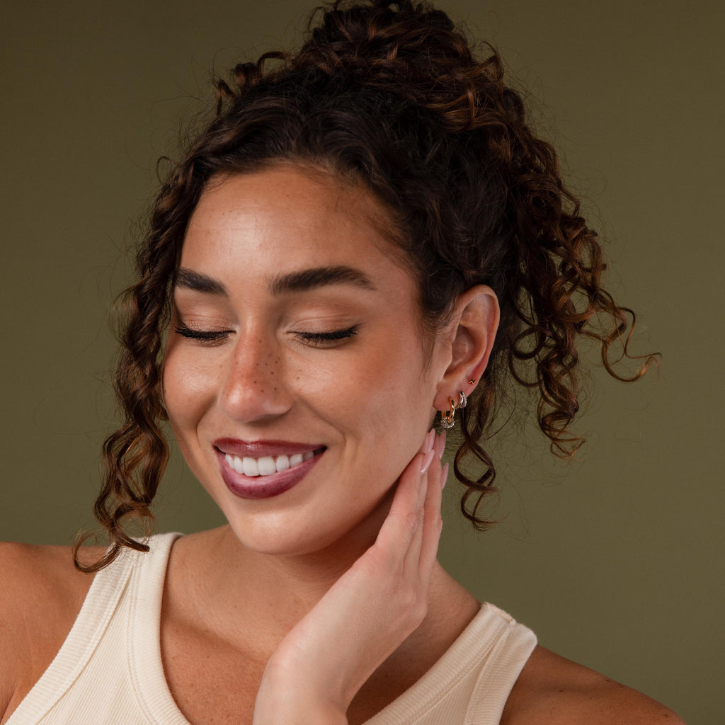 Image of a model showcasing a styled look with our Mixed Metal Pave Hoops in Gold