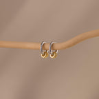 Our Mixed Metal Pave Hoops in White Gold hung on a wooden stick
