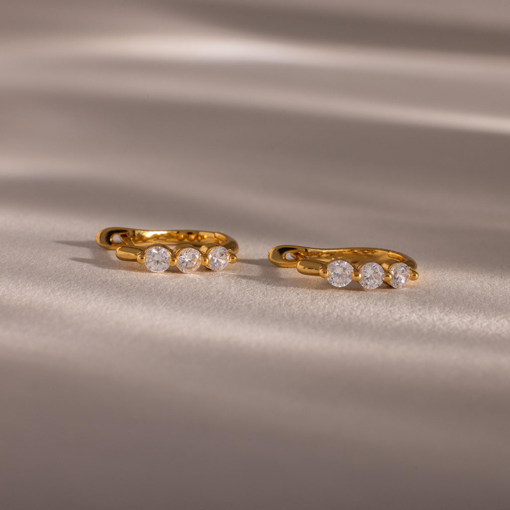 Flatlay of our Lace Diamond Hoops in 18K Gold