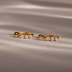 Flatlay of our Lace Diamond Hoops in 18K Gold