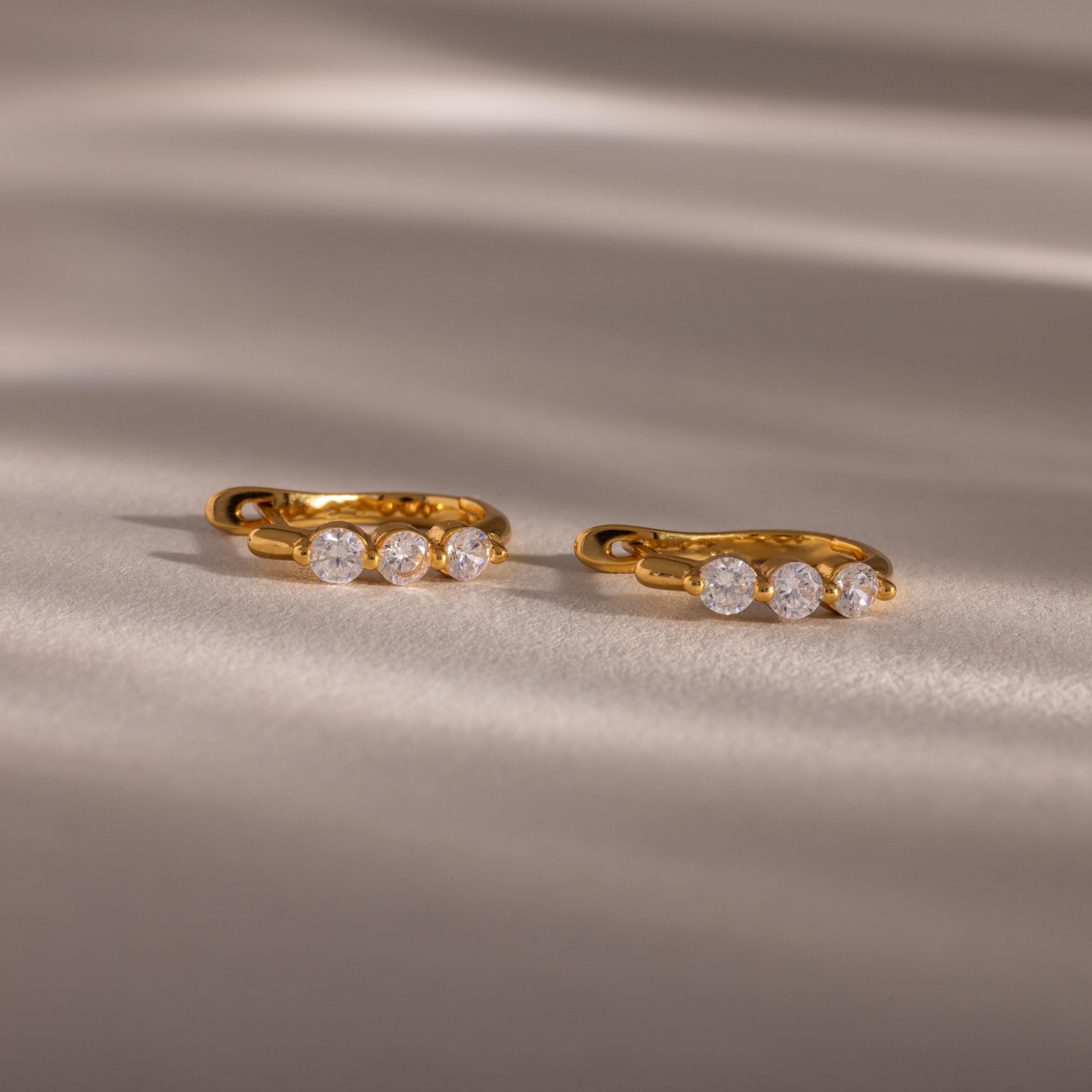 Flatlay of our Lace Diamond Hoops in 18K Gold