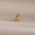 Rounded Pearl Flower Studs in 18K Gold feature pearl centers and diamond-like accents, making them perfect for bridesmaid jewelry. These elegant flower studs stand out beautifully against a neutral beige background.