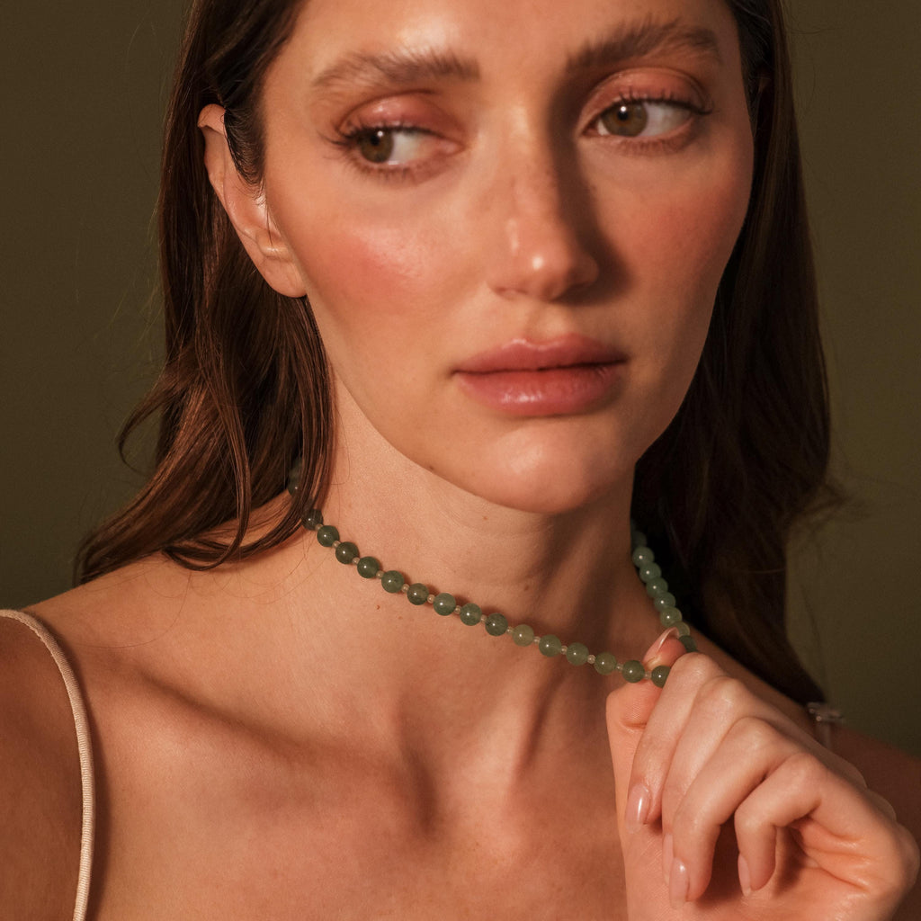 Woman with natural makeup wearing a stunning Jade Choker Necklace in Silver, looking off to the side.