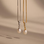 The Diamond Pearl Droplet Necklace features elegant pearls and sparkling diamonds on either a silver or gold chain, making it the perfect accessory for any occasion.