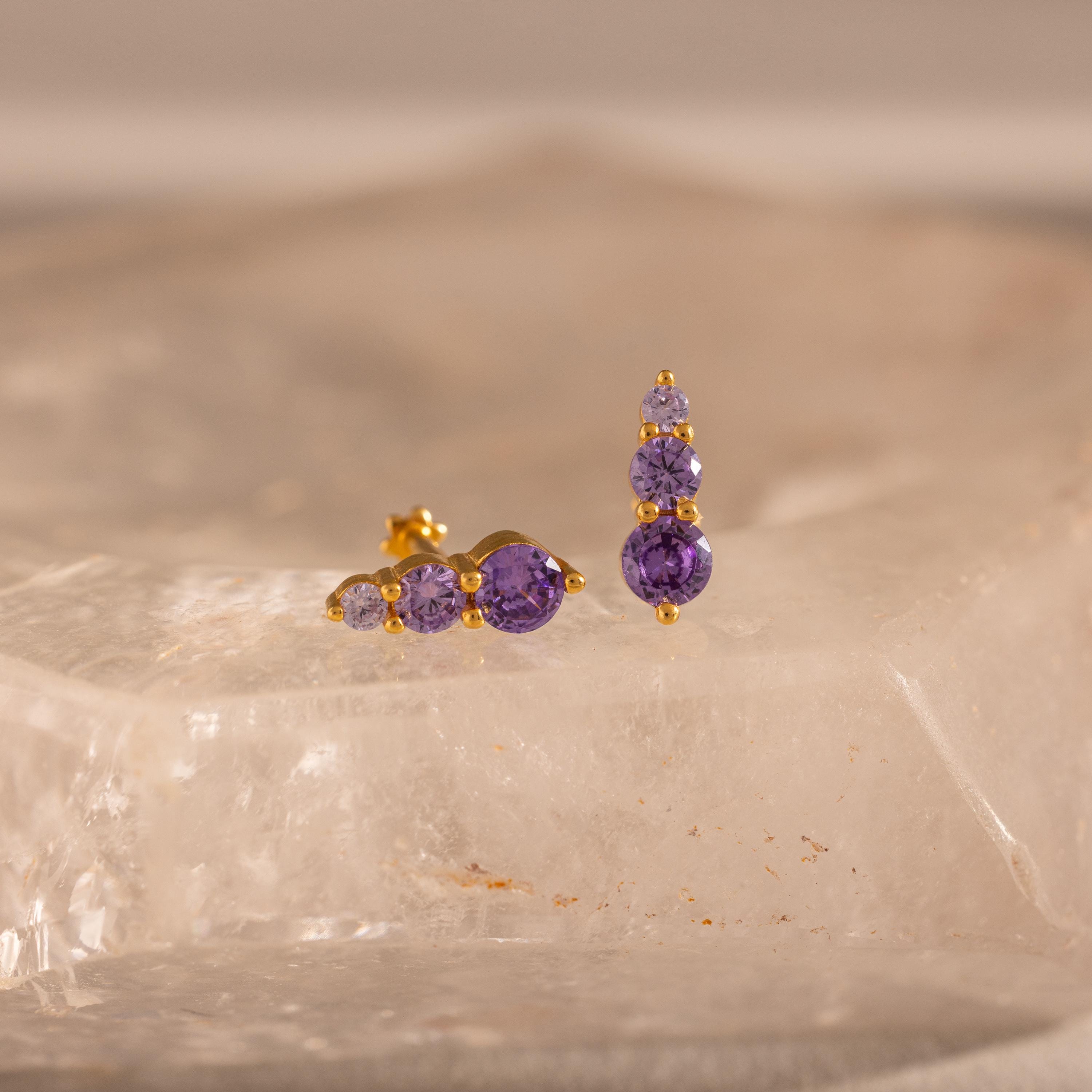 Ombre Birthstone Flatback Studs featuring three purple gems each, shown on a clear textured surface—an ideal personalized gift.