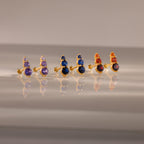 The Ombre Birthstone Flatback Studs feature three gold pairs with purple, blue, and orange gemstones—perfect for a personalized gift.