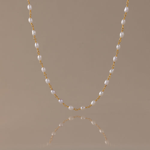 Aurora Pearl Station Necklace with luminous freshwater pearls connected by fine gold chain links.