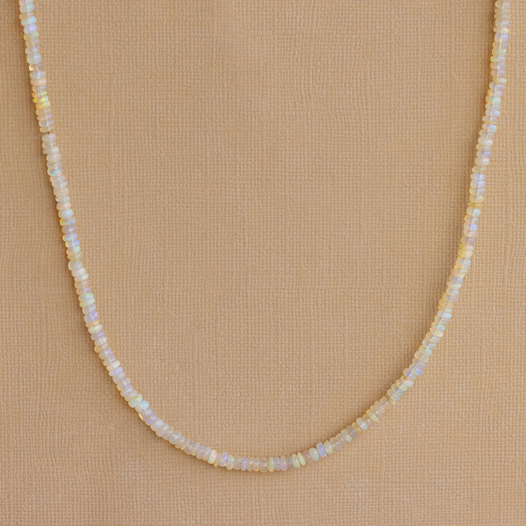 Opal Beaded Necklace showcased on a tan textured background, ideal for bringing bohemian charm to any outfit.