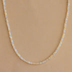 Opal Beaded Necklace showcased on a tan textured background, ideal for bringing bohemian charm to any outfit.