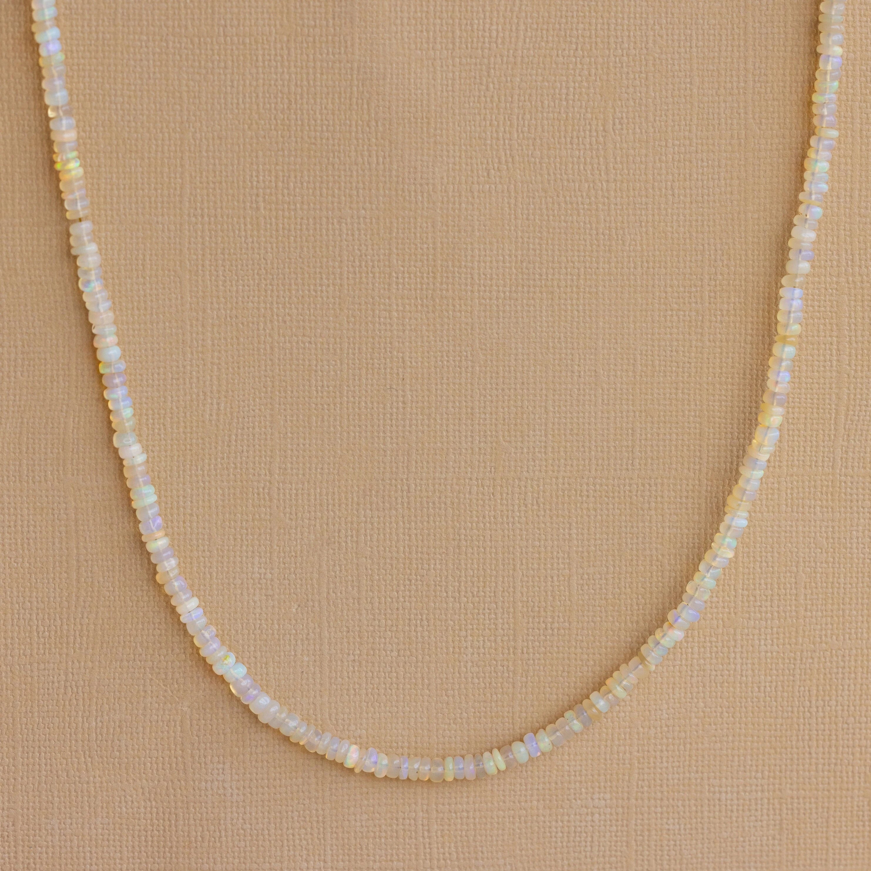 Opal Beaded Necklace showcased on a tan textured background, ideal for bringing bohemian charm to any outfit.
