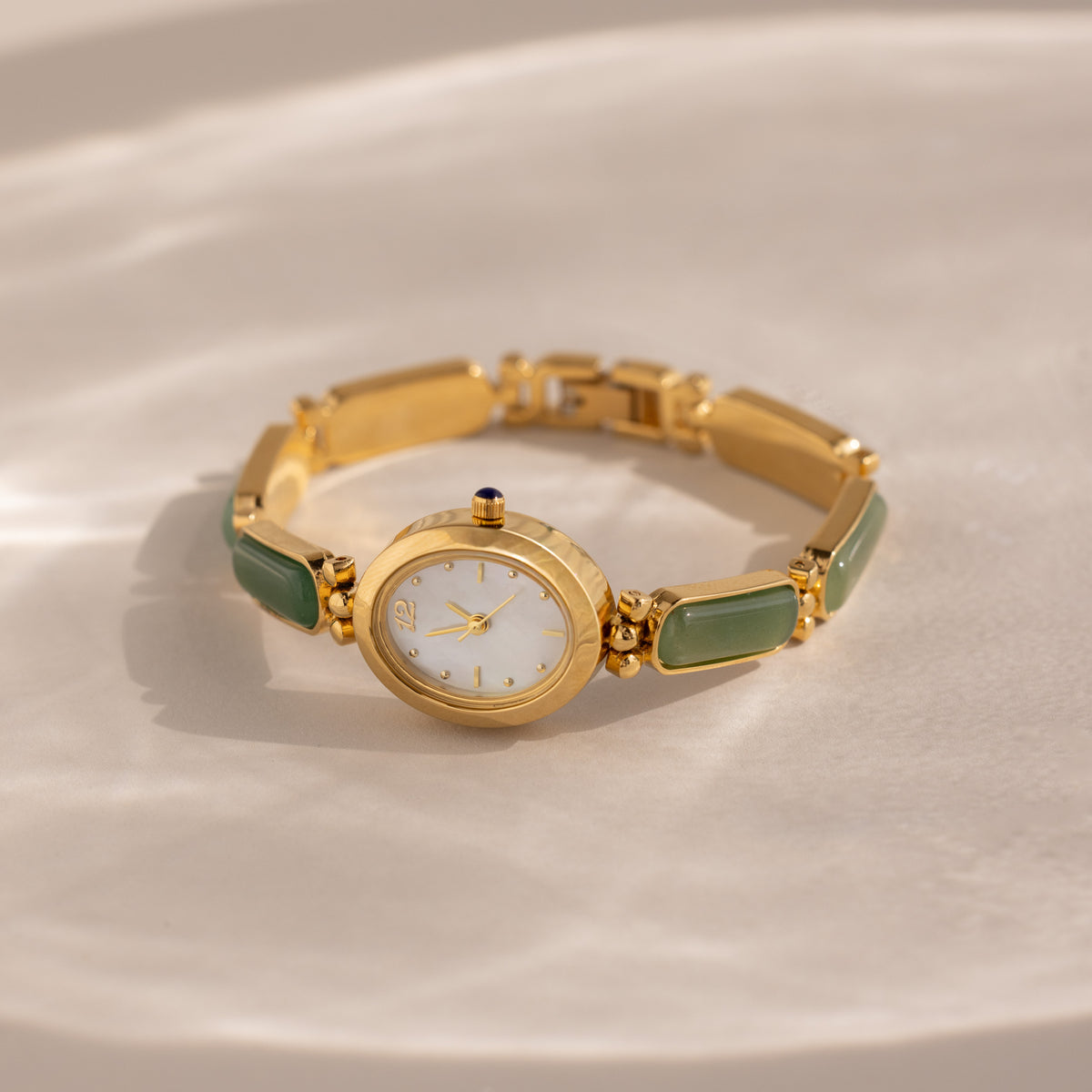 Our Jade Band Timepiece watch in gold on a beige background