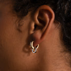 Close-up of an ear wearing Mixed Metal Circle Hoops—two gold and one silver—against brown skin, highlighting the beauty of these versatile earrings for jewelry lovers.
