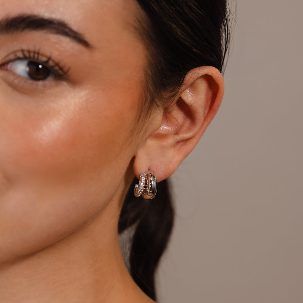 Close-up of a woman's ear wearing Duo Pave Dome Studs in White Gold, featuring a subtle textured design that's perfect for everyday jewelry.