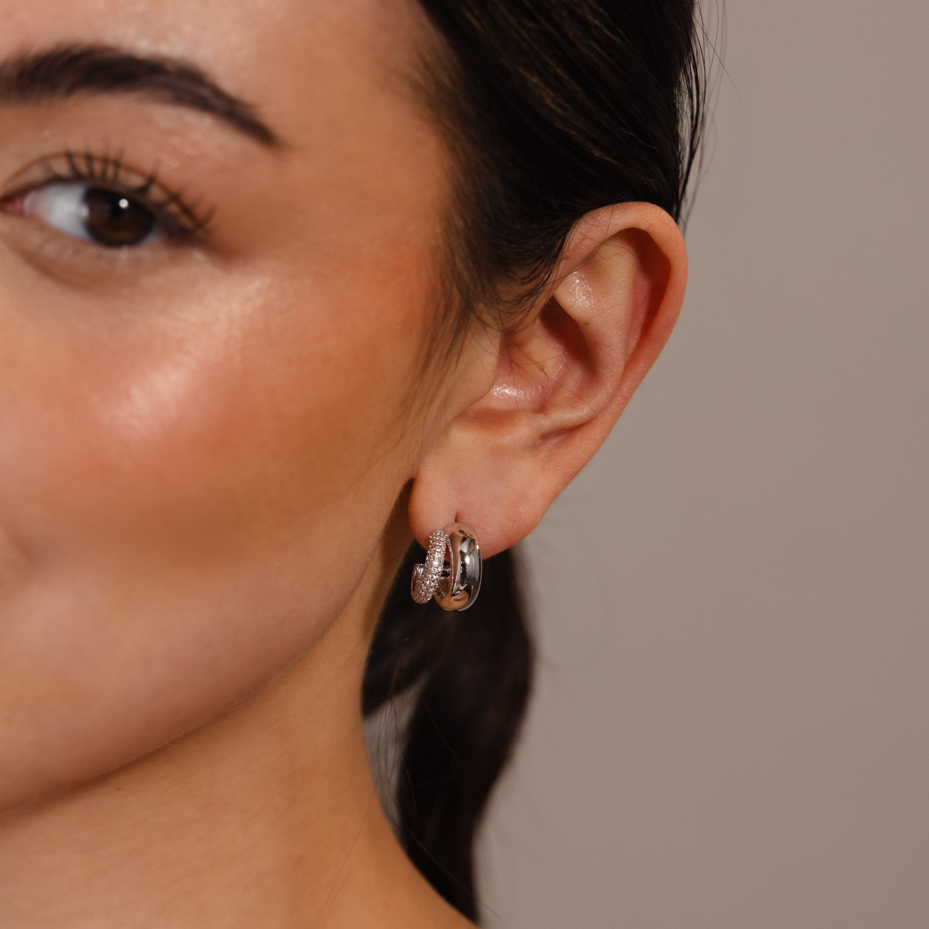 Close-up of a woman's ear wearing Duo Pave Dome Studs in White Gold, featuring a subtle textured design that's perfect for everyday jewelry.