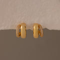 Duo Pave Dome Studs in 18K Gold feature one half plain and the other half pavé-set with clear crystals, making them perfect for everyday wear. Shown against a neutral background.