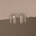The Duo Pave Dome Studs in White Gold feature one plain and one pavé-encrusted earring, perfect for adding a subtle sparkle to your everyday jewelry collection.