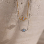 Two Opal Eye Necklaces—one in gold, one in silver—each with a blue stone center. Wear as an eye pendant or lucky talisman.