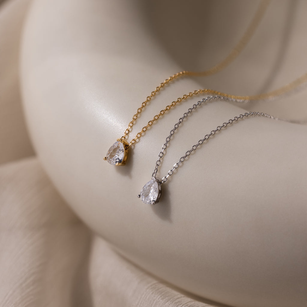 The Rae Diamond Necklace, available in gold and silver teardrop pendants, offers a timeless, elegant look—perfect for anyone seeking classic diamond jewelry.