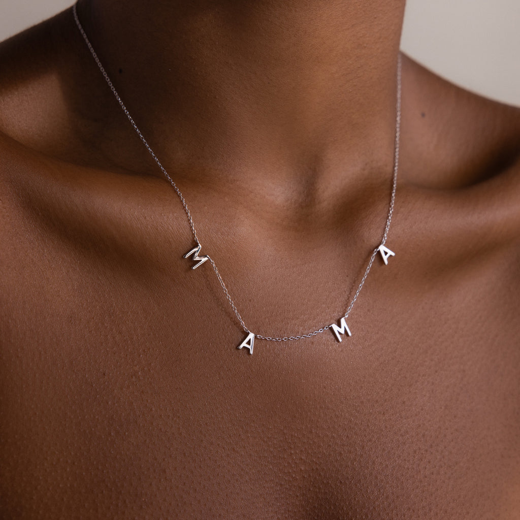 The Mama Letter Necklace is a timeless symbol of motherhood, shining elegantly on the neck—a perfect gift for any mom.