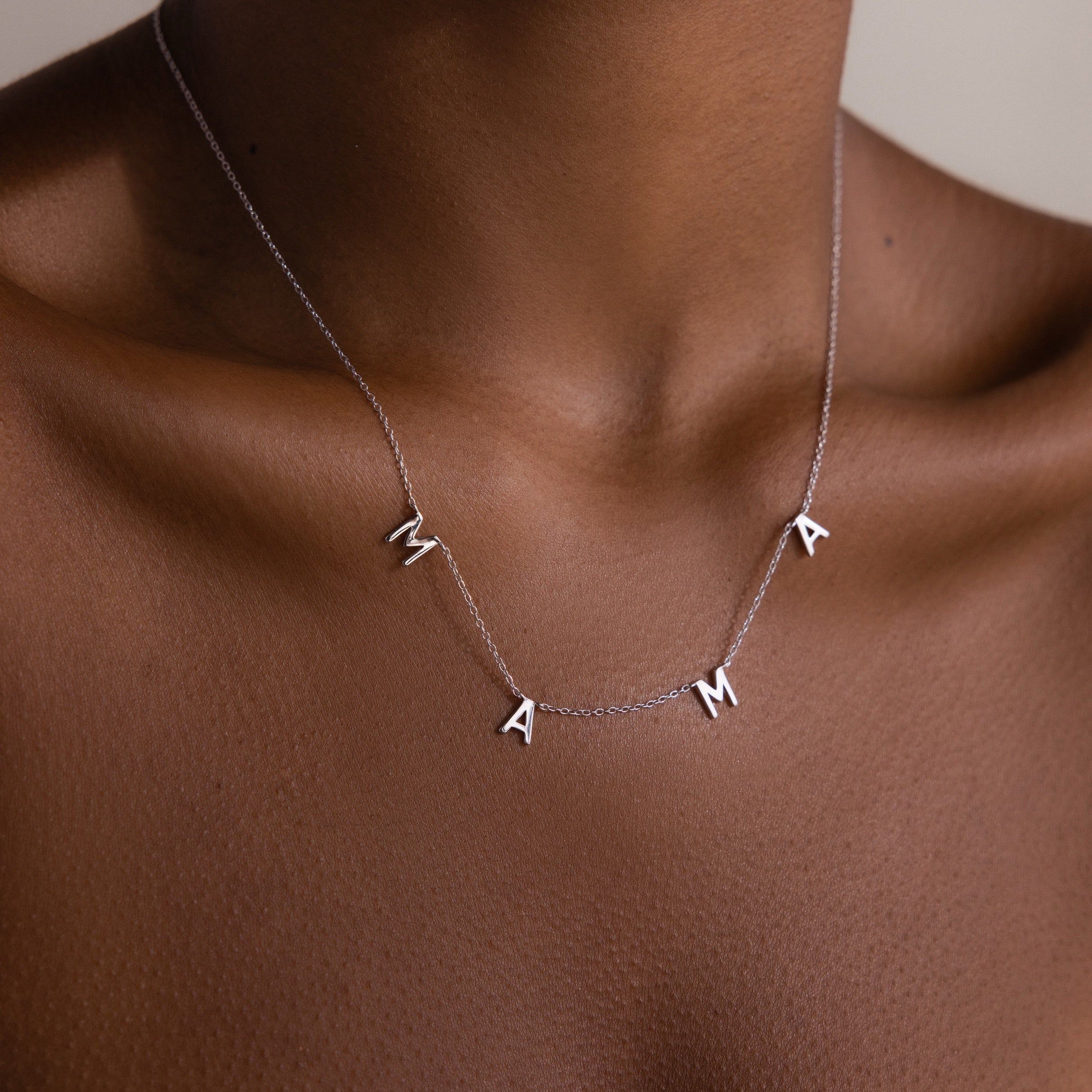 The Mama Letter Necklace is a timeless symbol of motherhood, shining elegantly on the neck—a perfect gift for any mom.