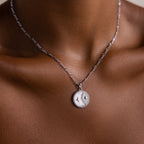 Close-up of the Gabi Coin Necklace in Silver featuring a round sun and moon pendant—ideal for fans of vintage-inspired necklaces and minimal jewelry.