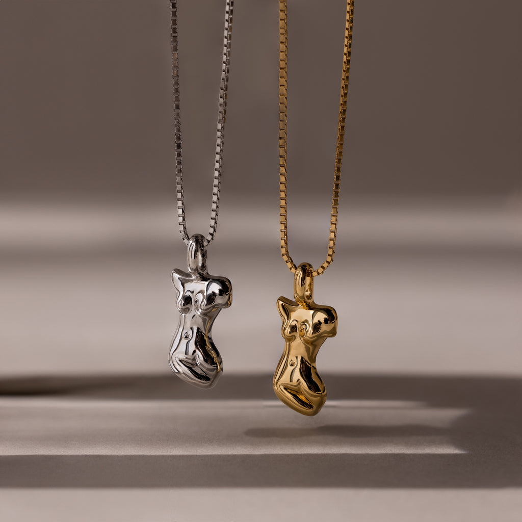 The Kinn Body Necklace is featured in gold and silver with an abstract body pendant, offering unique empowerment jewelry for bold style lovers.