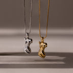The Kinn Body Necklace is featured in gold and silver with an abstract body pendant, offering unique empowerment jewelry for bold style lovers.