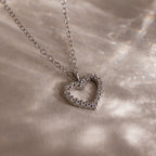 The Forever Pave Heart Necklace in Silver features small sparkling stones on a delicate chain—an elegant choice for bridal jewelry.