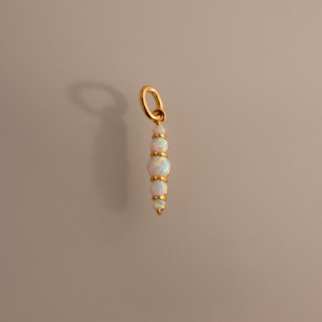 The Ombre Lace Opal Charm features four stacked opal beads on a gold pendant—the perfect personalized accessory or thoughtful birth month gift.