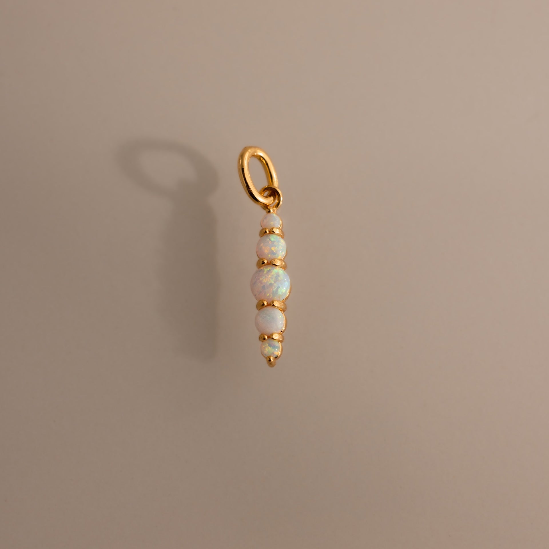 The Ombre Lace Opal Charm features four stacked opal beads on a gold pendant—the perfect personalized accessory or thoughtful birth month gift.