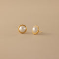 The Pearl Bezel Studs—gold stud earrings with round white pearls—add timeless elegance to any look, making them a perfect choice for every occasion.