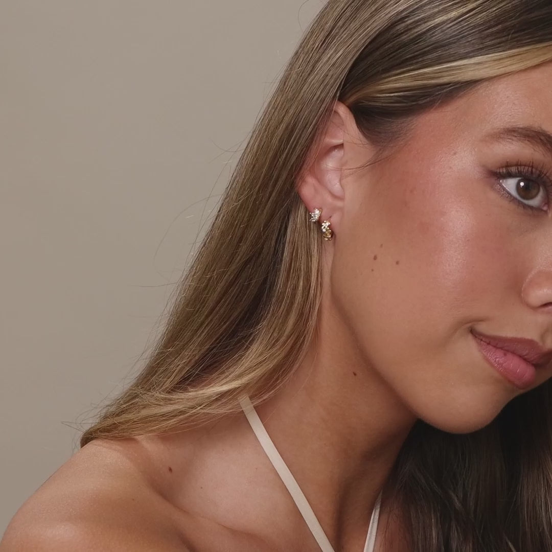 Video of a model wearing our Diamond Leaf Hoops in 18K Gold