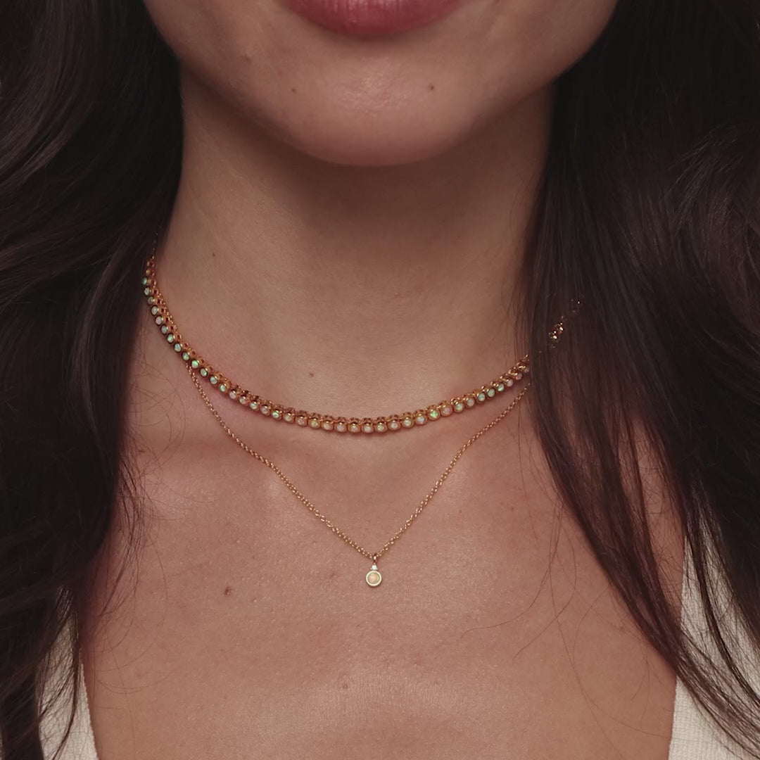 Video of a model wearing our Opal Diamond Necklace in Gold, styled with our Opal Bezel Tennis Necklace