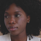 Model wearing mismatched set of 3 dainty gold Opal and CZ Diamond Celestial Earrings with moon, heart, and star studs.