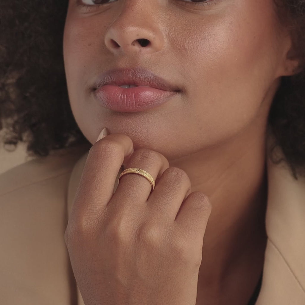 Model showcasing gold filigree ring on hand with close-up and movement.