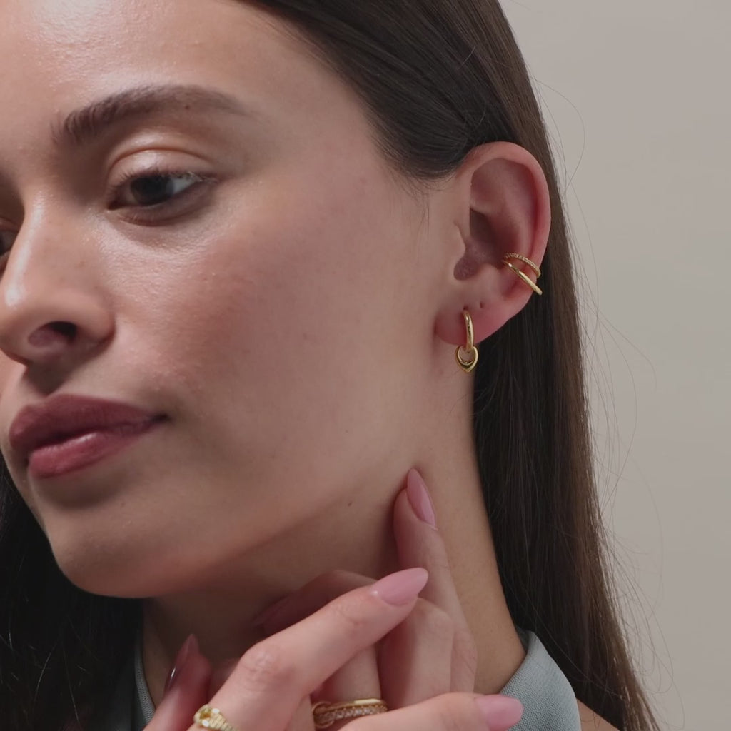 Video of a model wearing our Tiny Teardrop Huggies in Gold