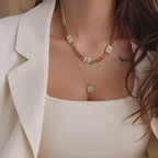Model wearing a Gold North Star Opal Trio Necklace layered with a Pave Pearl Initial Pendant Necklace.