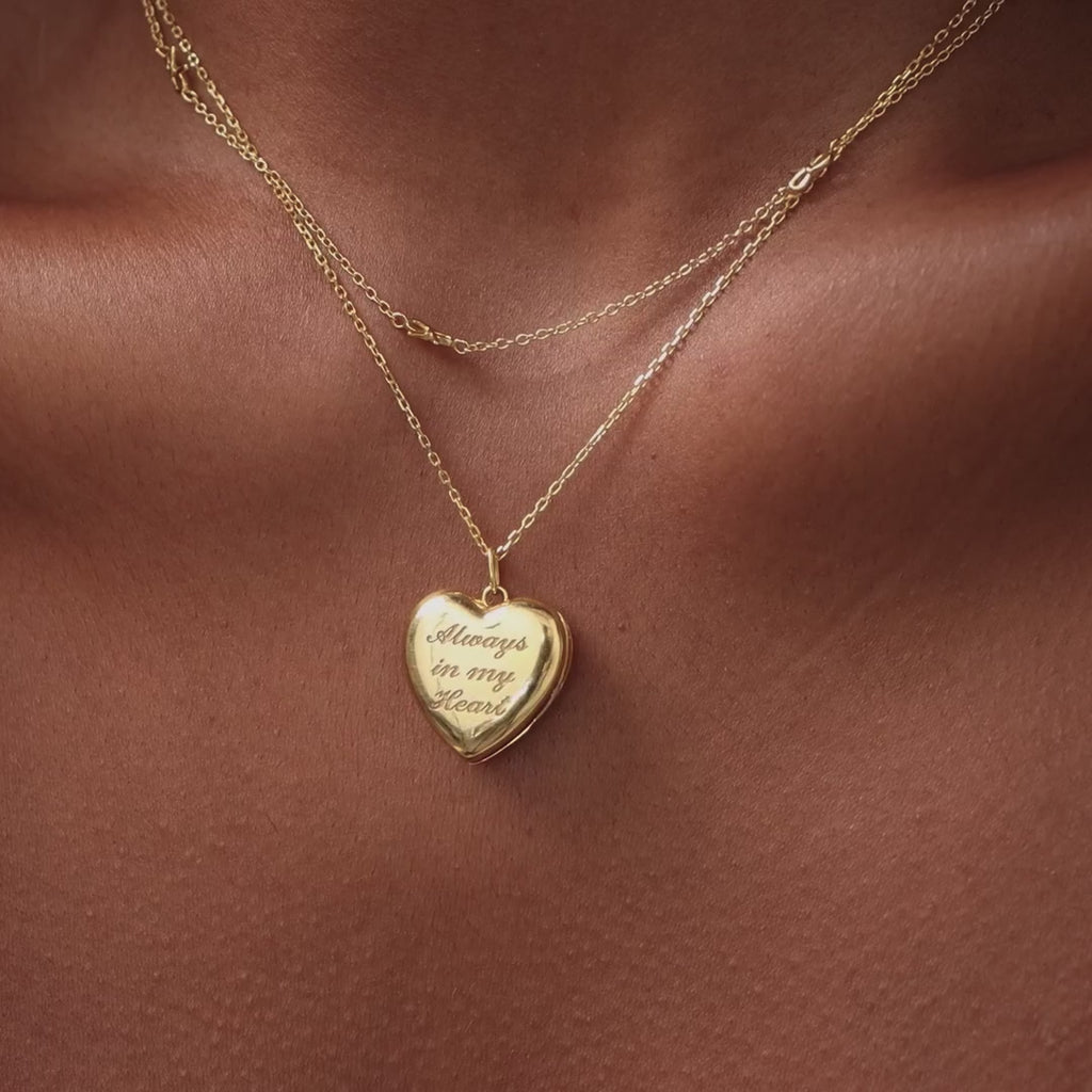 Video of a model wearing our Engraved Heart Locket Necklace in 18K Gold with a chain necklace