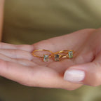 Three Agate Emerald Rings held in a hand, highlighting the natural variation in each stone's pattern and color.
