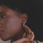 Model wearing set of 3 dainty gold CZ Diamond Constellation Stud Earrings as a stacked set