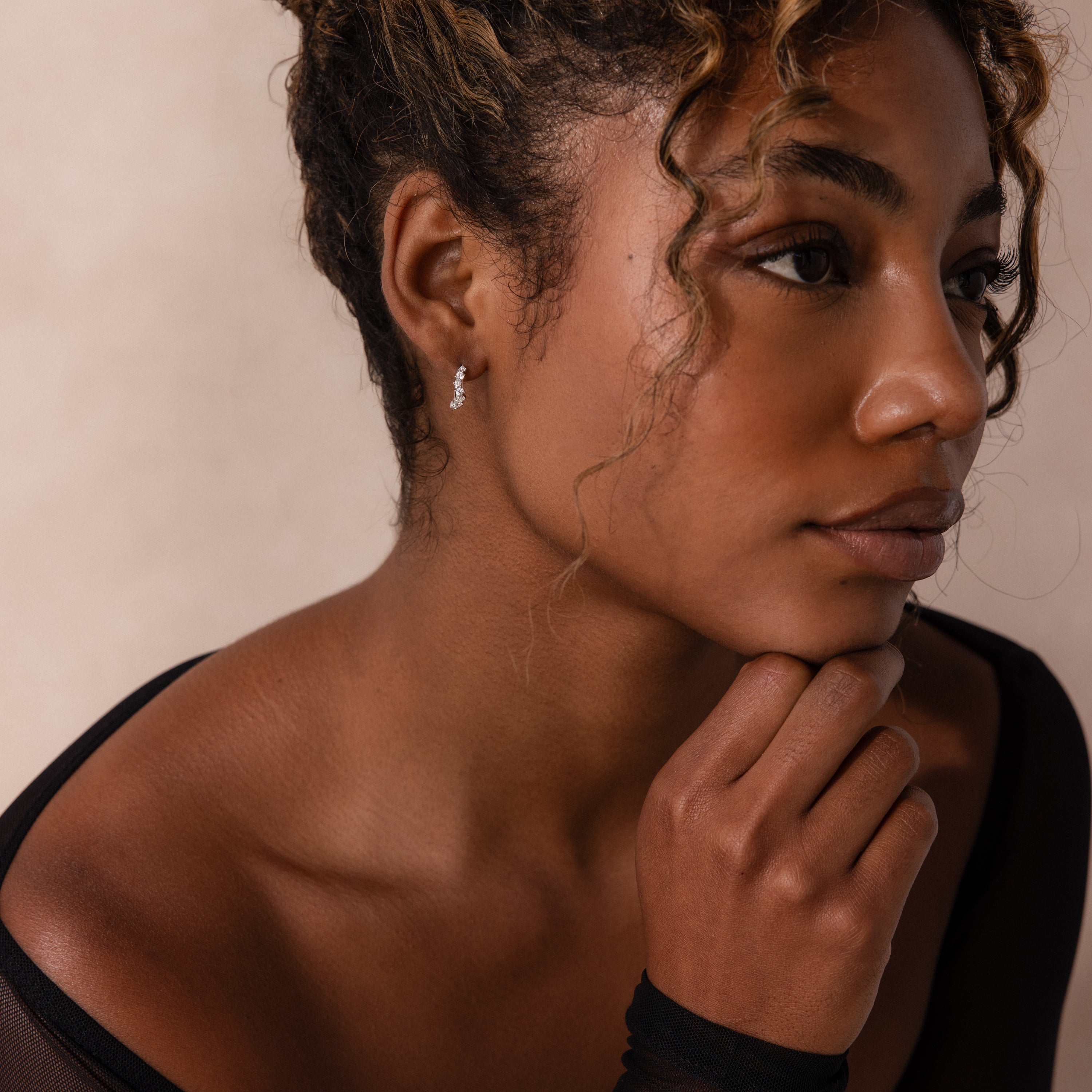 Model wearing Marquise Cluster Hoop Earrings in silver with clustered CZ diamond stones.