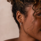 Model wearing Marquise Cluster Hoop Earrings in silver with clustered CZ diamond stones.