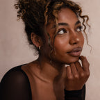 Model wearing Marquise Cluster Hoop Earrings in gold with clustered CZ diamond stones.