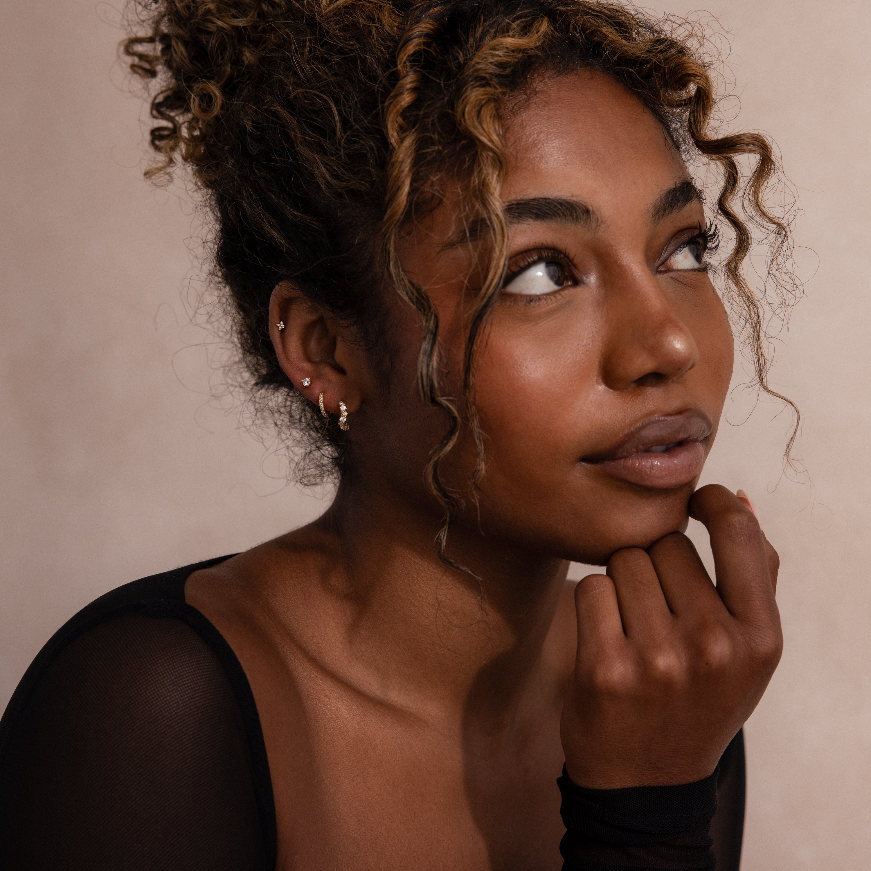 Model wearing Marquise Cluster Hoop Earrings in gold with clustered CZ diamond stones.