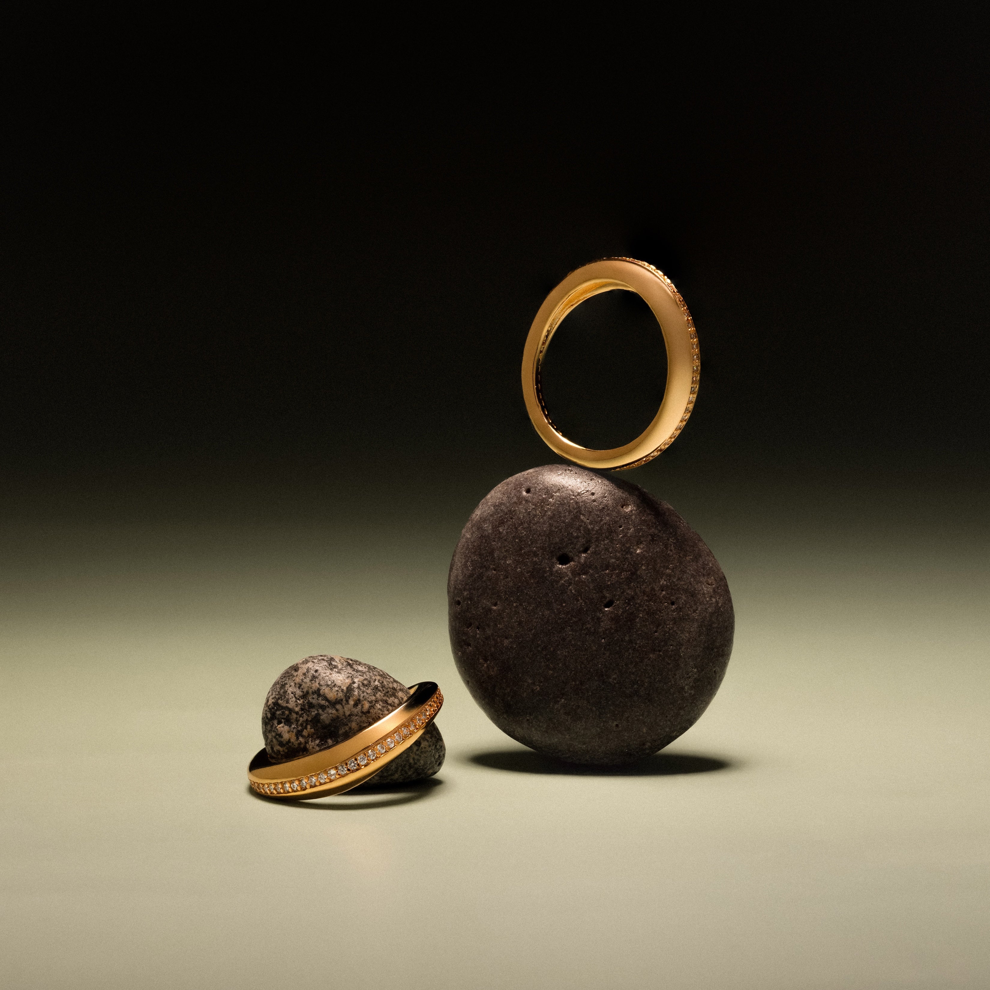 The Pave Curve Dome Ring is displayed on smooth dark stones against a simple, softly lit background—a timeless everyday stack.