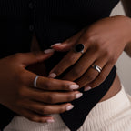 Close-up of hands with manicured nails wearing the Duo Form Ring Set, styled against a black ribbed top and cream pants.