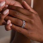 Close-up of a hand with manicured nails wearing the Crystal Stacking Ring Set in Silver, sparkling with crystal gemstones on the ring finger.